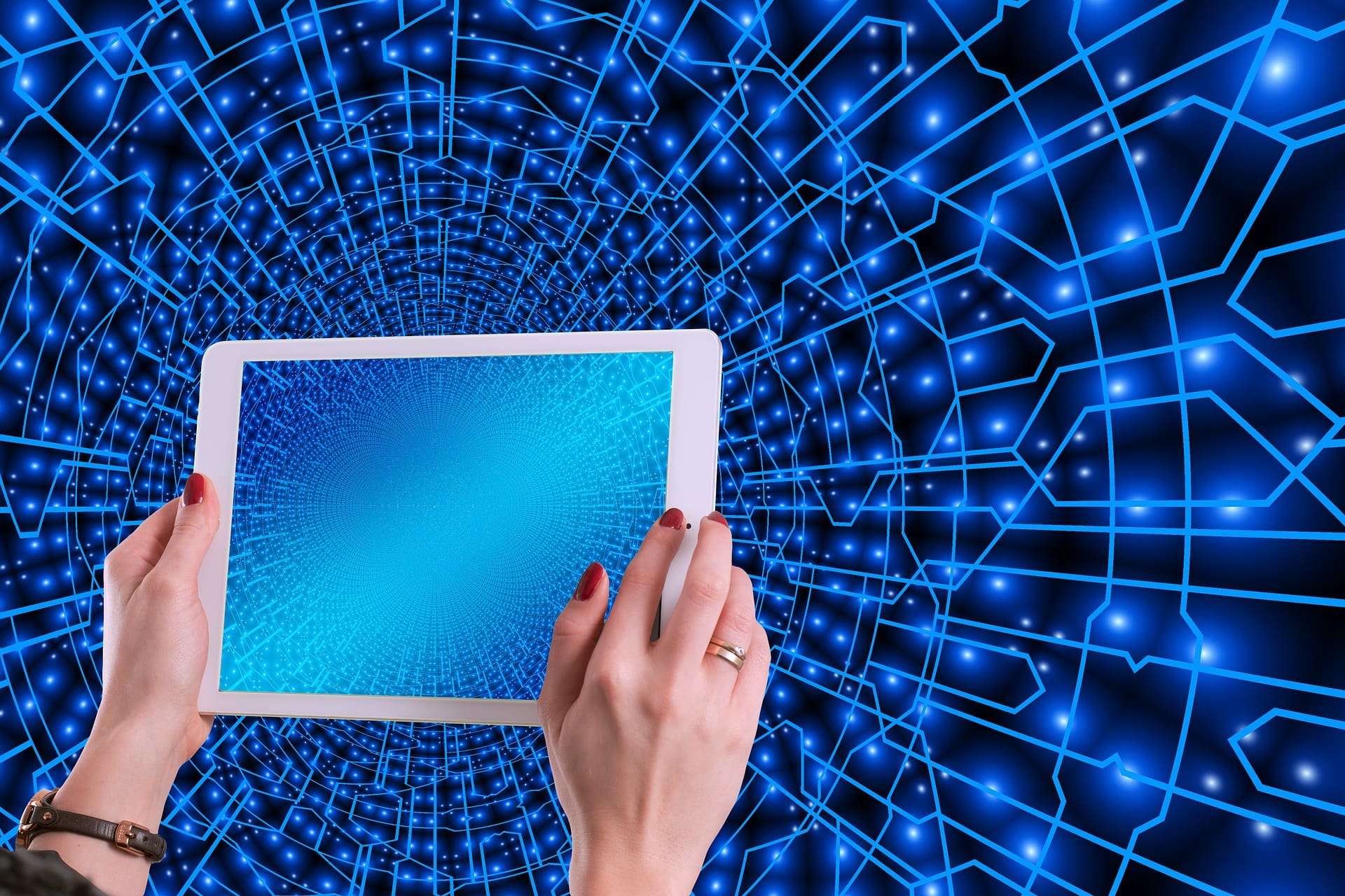 Hands holding atablet computer on a digital background