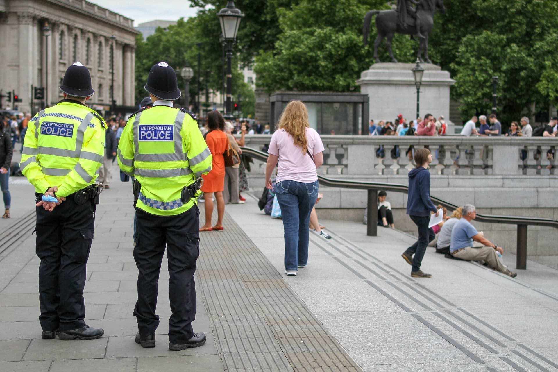 Two policemen looking at crowds