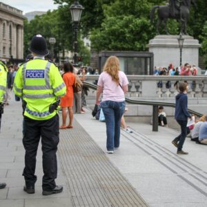 Two policemen looking at crowds